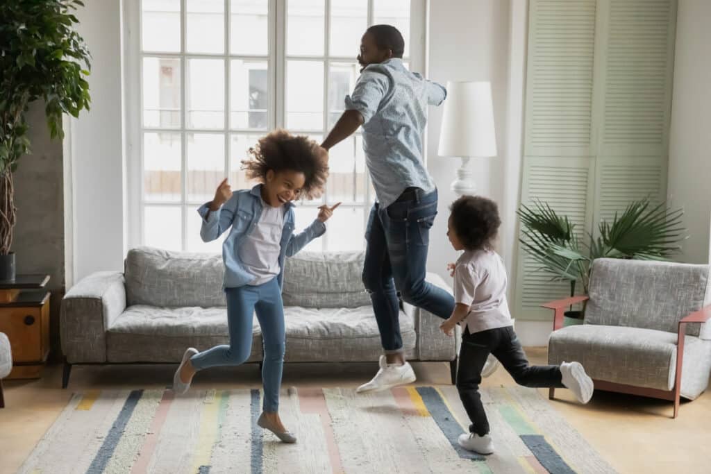dad dancing around with his two kids
